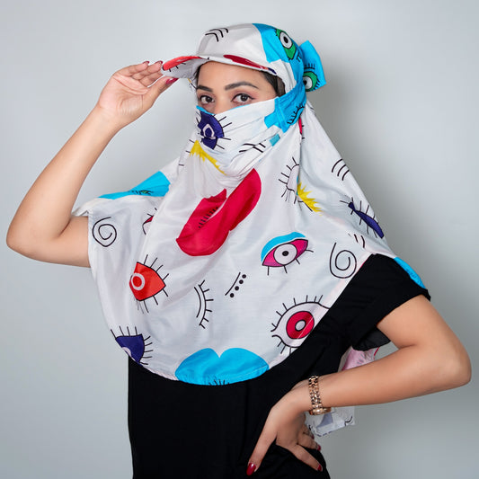 Woman wearing a colorful headscarf with abstract designs on a plain background