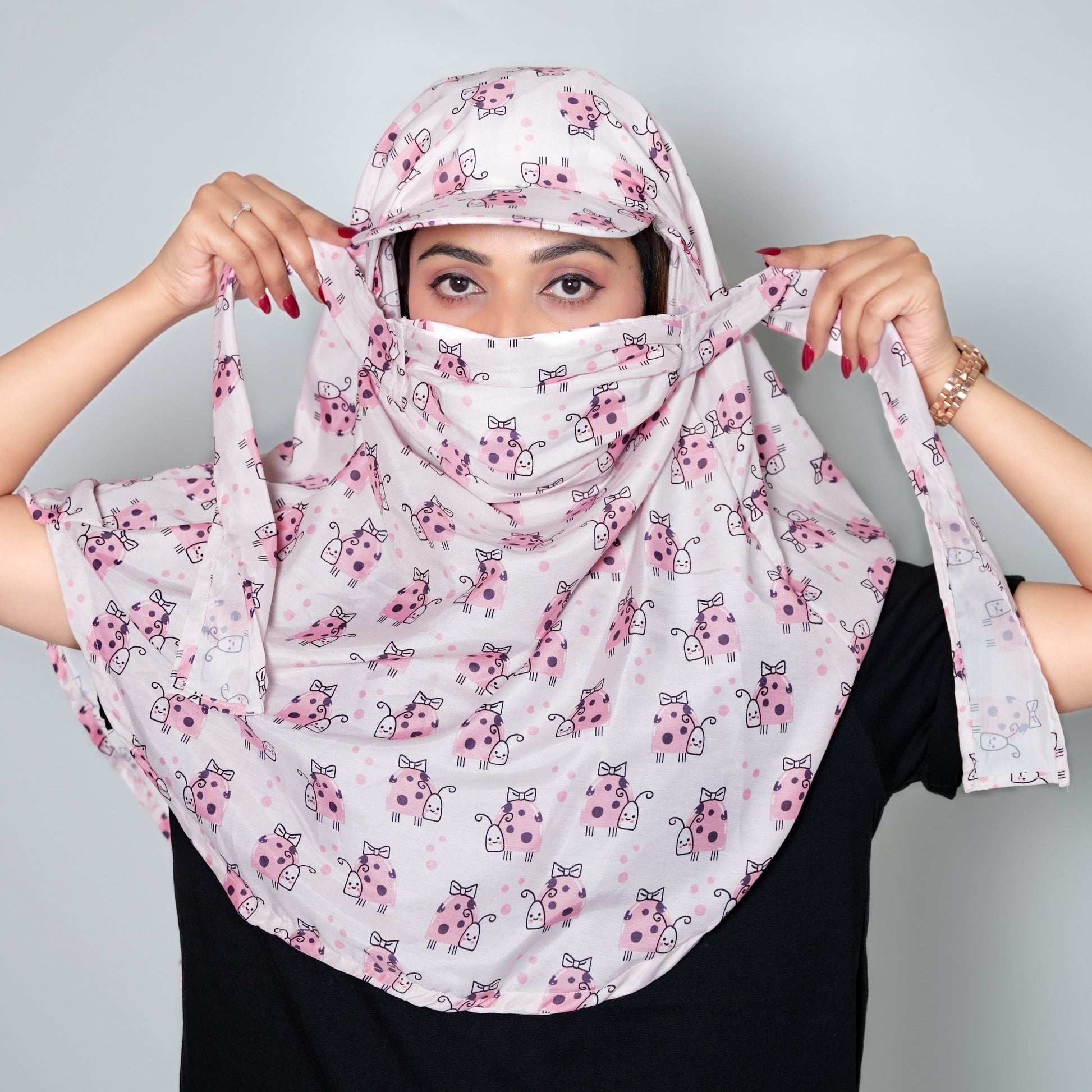 Woman wearing a floral headscarf against a plain background