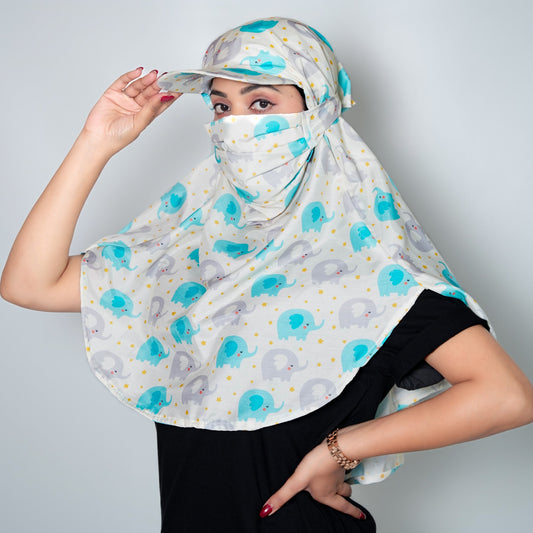 Person wearing a patterned headscarf with elephants and blue circles on a plain background