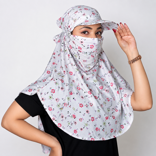 A woman wearing a light gray floral sun protection headscarf with a matching visor and face covering, styled over a black t-shirt against a plain light gray background.