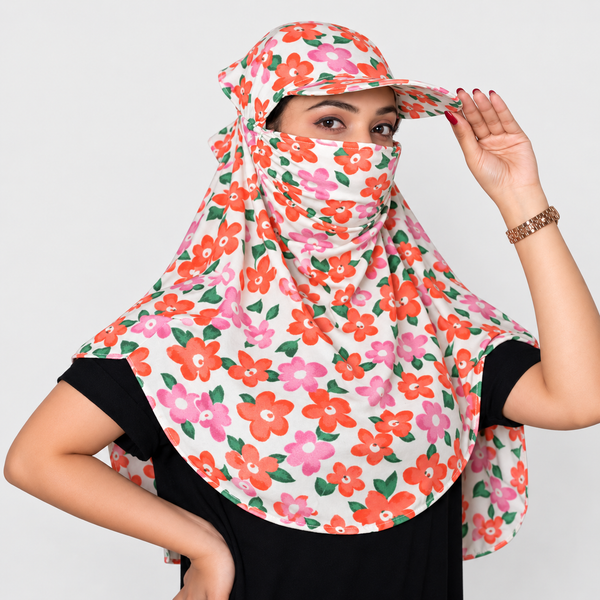A woman wearing a floral print sun veil and matching sun hat, styled with a black t-shirt against a light gray background.