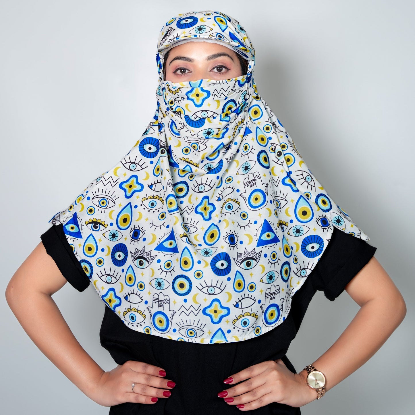 Person wearing a colorful patterned scarf against a plain background