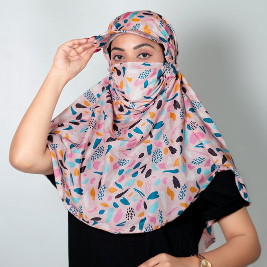 Woman wearing a colorful patterned cap scarf against a plain background